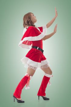 Christmas girl push something, full length pose isolated.