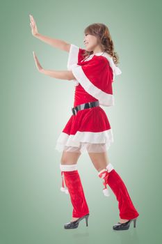 Christmas girl push something, full length pose isolated.