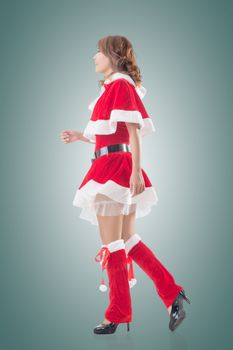 Asian Christmas girl walk, full length portrait. Side view.