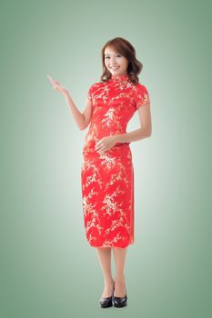 Chinese woman dress traditional cheongsam at New Year and introducing, full length portrait isolated.