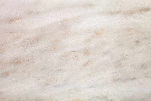 Tan marble stone texture background with ripples.