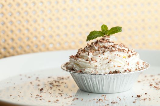 Banana caramel parfait dessert with fresh whipped cream and chocolate shavings. Shallow depth of field.