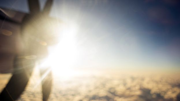 Defocused and blurred image Airplane propeller engine against on sky