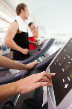 Row of people working out on treadmills at the gym