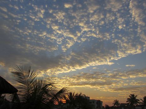 Bright Sunset clouds over the city horizon