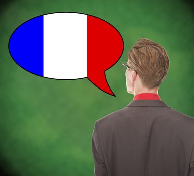 Young business man speaking french on school board background