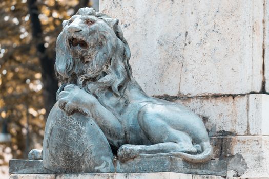 Bronze lion placed on the base of a monument
