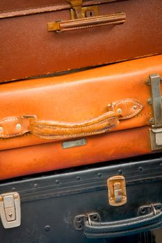 background of well used vintage suitcases packed for traveling