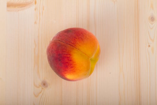 Fresh peaches on a light wood background