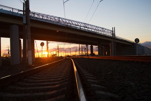 The bridge over the railway in the early summer morning