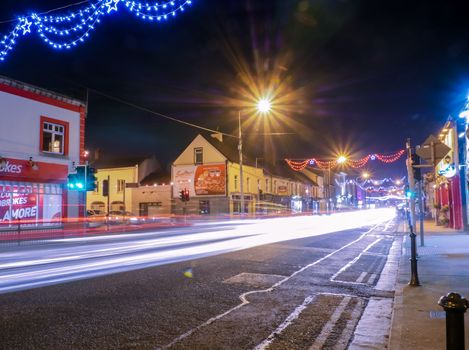 Car lights at night in small Irish town - Tullamore