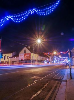 Car lights at night in small Irish town - Tullamore