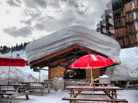 deep snow on the roof of a mountain chalet cabin in la plagne