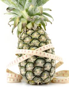 pineapple with measuring tape isolated on white background concept diet