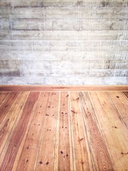 Empty room interior with wooden floor and concrete wall.