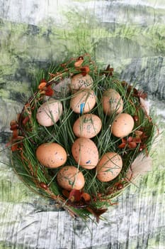 Easter wreath with eggs and decorations on green cloth