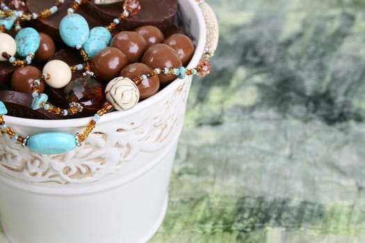 Ornate bucket filled with chocolates and beads