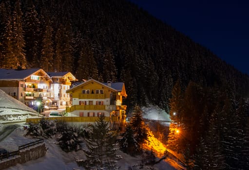 Night view at the ski resort at the mountain slopes (Dolomites, Italy)