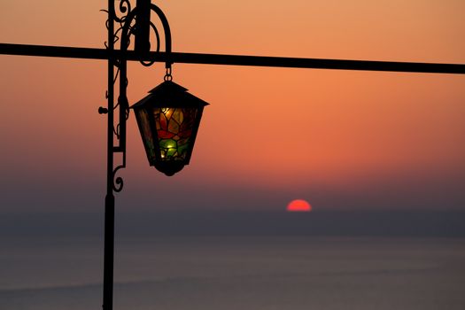 Nostalgic Reminiscence with stained glass lantern at sunset at Kaliakra headland, Bulgarian Black Sea Coast