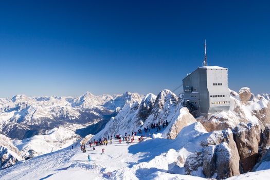 At the Marmolada glacier skiing slopes at sunny winter day (Dolomites, Italy)
