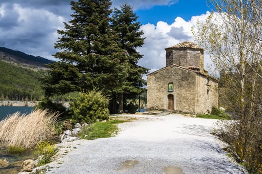 Photo of an orthodox church in the nature next to lake