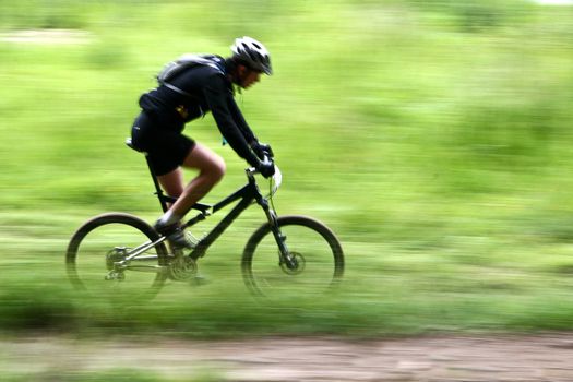 Mountain bike race in a forest in denmark,  Shot with low shutter speed to achieve motion blur