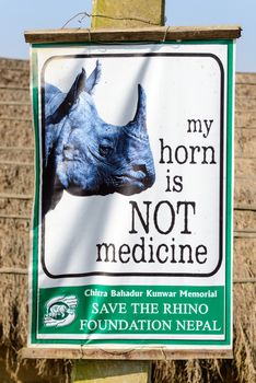 SAURAHA, NEPAL - 23 DECEMBER 2014: A board from Save the Rhino Foundation Nepal reads 'my horn is NOT medecine'. The rhino is an endangered species.