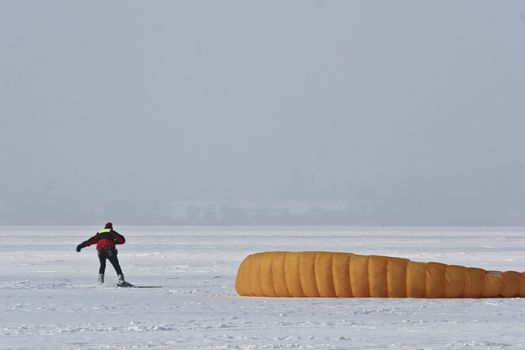 Ice surfing (kite) a lake in denmark in winter
