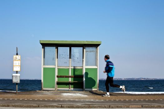 View of the danish east coast bus stop and man running