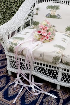 Bouquet of pink roses on sofa