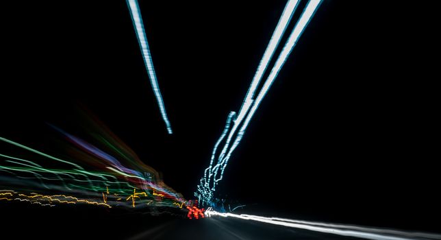 Colored abstract car lights at night on motorway