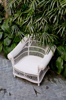 Rattan chair with green trees at outdoor
