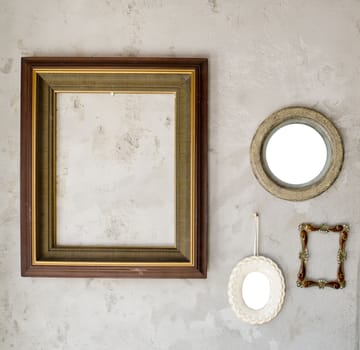 Set of different modern and ancient mirrors and photo frame.