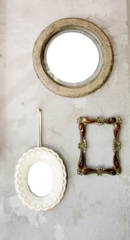 Set of different modern and ancient mirrors and photo frame.