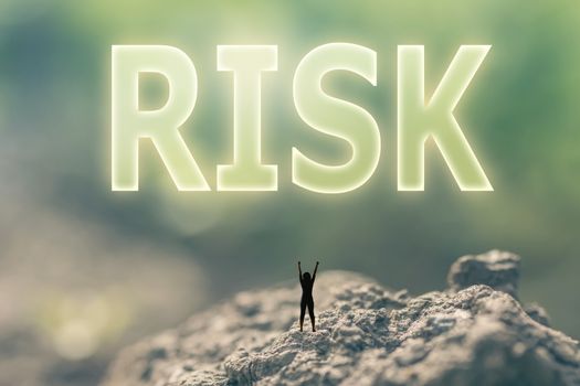 Concept of risk with a person stand in the outdoor and looking up the text over the sky in nature background.