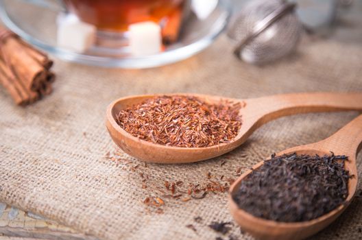 dry tea is in wooden spoons, in a studio