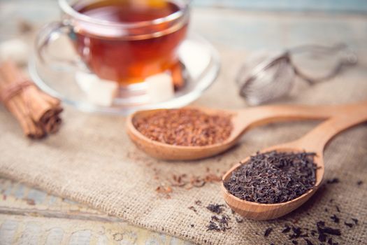 dry tea is in wooden spoons, in a studio