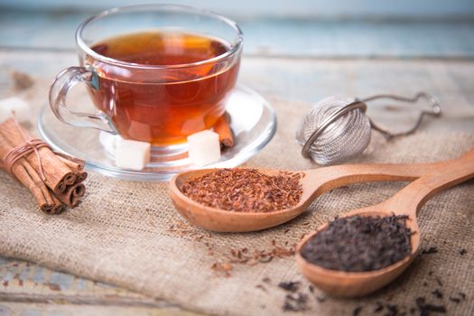 dry tea is in wooden spoons, in a studio