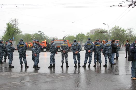 Moscow, Russia - May 9, 2012. March of communists on the Victory Day. Staff of the Russian police protects political procession