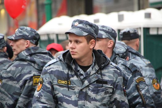 Moscow, Russia - May 9, 2012. March of communists on the Victory Day. Staff of the Russian police protects political procession