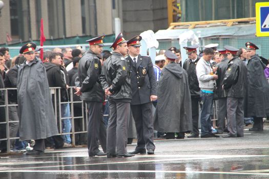 Moscow, Russia - May 9, 2012. March of communists on the Victory Day. The Russian police during a rain, near procession of communists