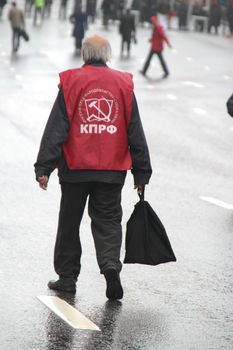 Moscow, Russia - May 9, 2012. March of communists on the Victory Day. The lonely old man the pensioner with a bag in hands, in day of procession of communists