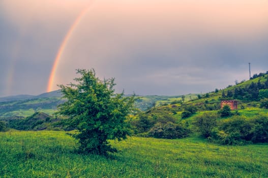 Rainbow over green landscape of mountainous Karabakh