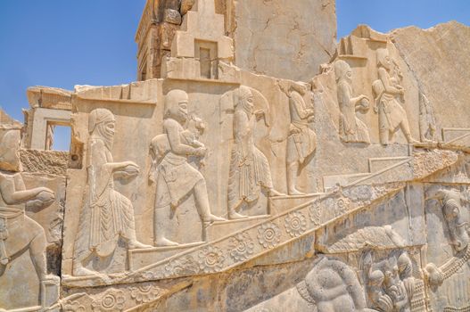 Figures on walls of ancient persian capital Persepolis in current Iran