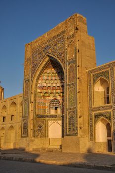 Side-view of the Abdulaziz Khan Madrassah (Museum of Wood Carving Art) in the setting sun, Uzbekistan