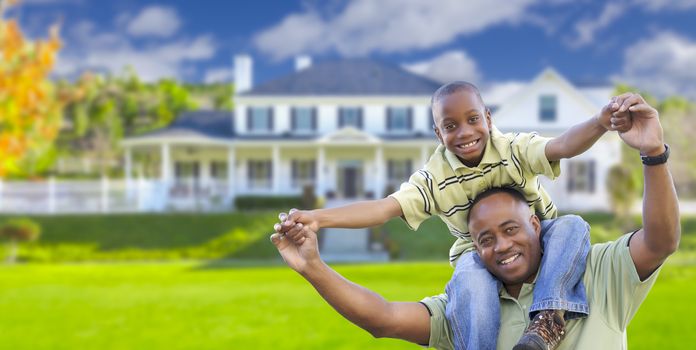 Playful African American Father and Son In Front Yard of Home.