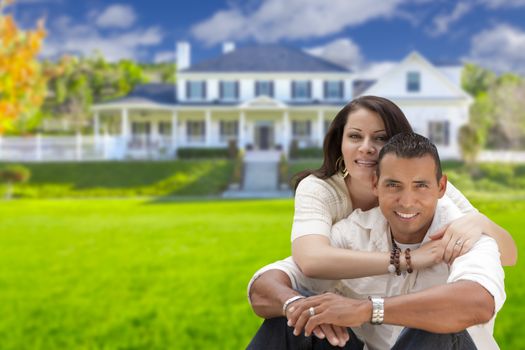 Young Happy Hispanic Young Couple in Front of Their New Home.