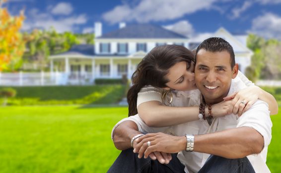 Young Happy Hispanic Young Couple in Front of Their New Home.