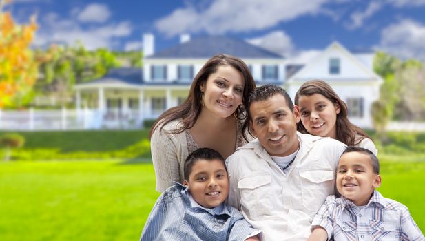 Happy Young Hispanic Family in Front of Their New Home.