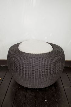 A modern design of rattan stool with white cushion